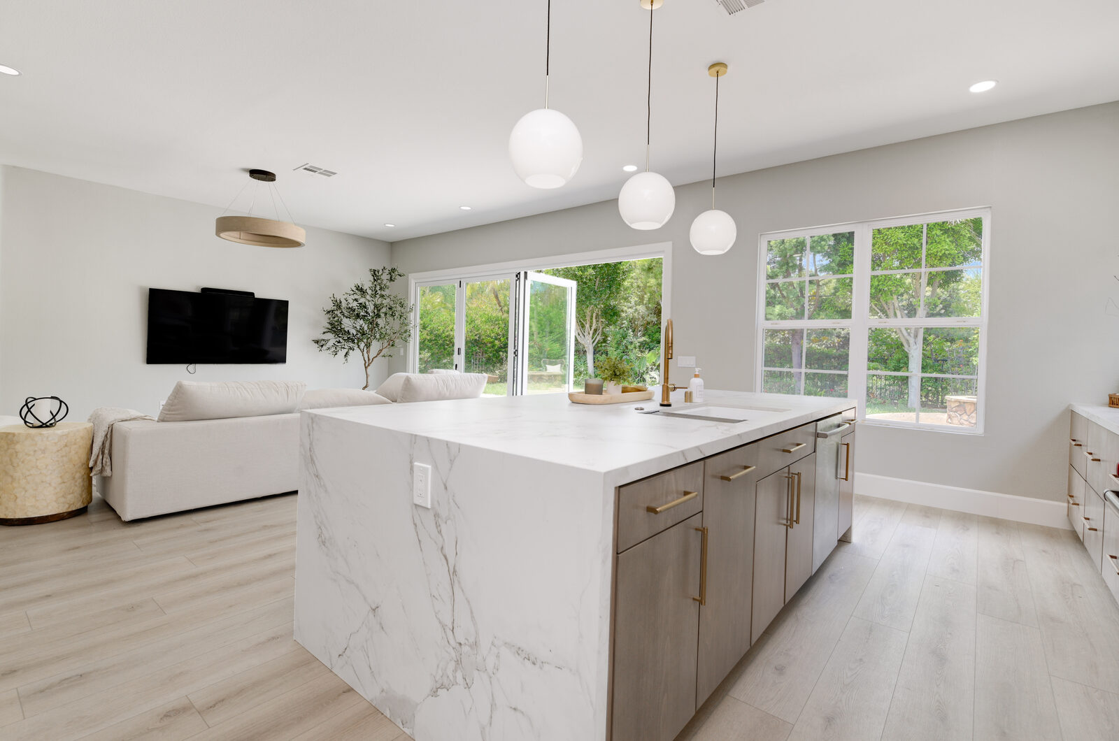 Open-concept kitchen opening to the living room through sliding glass doors